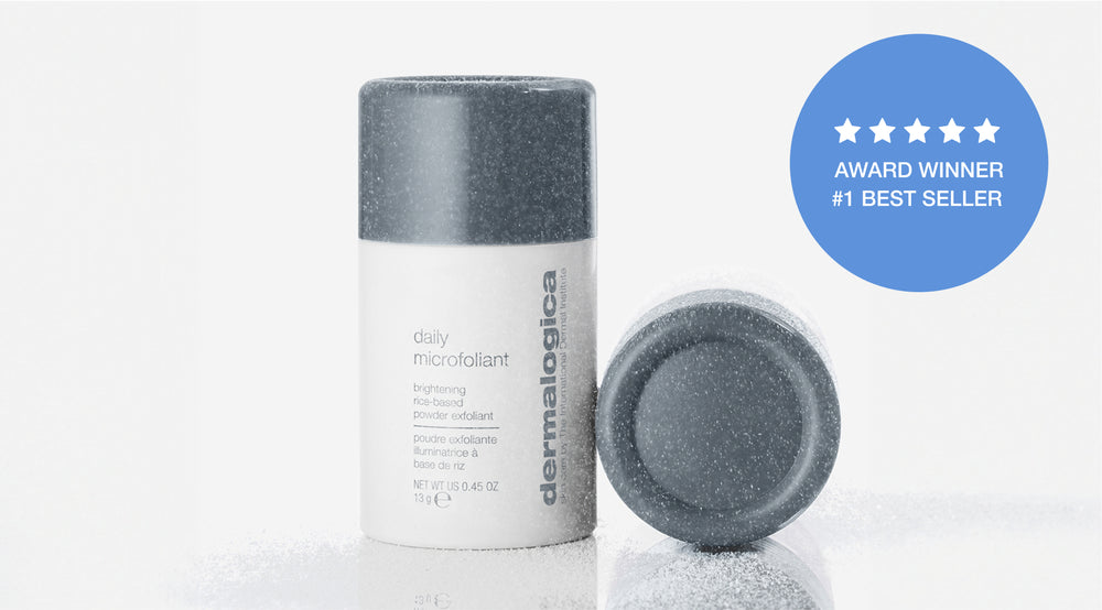 A white bottle of Dermalogica Daily Microfoliant with a gray cap stands upright, next to another cap lying on its side. Beside it, a blue badge reads: AWARD WINNER #1 BEST SELLER with five white stars above.