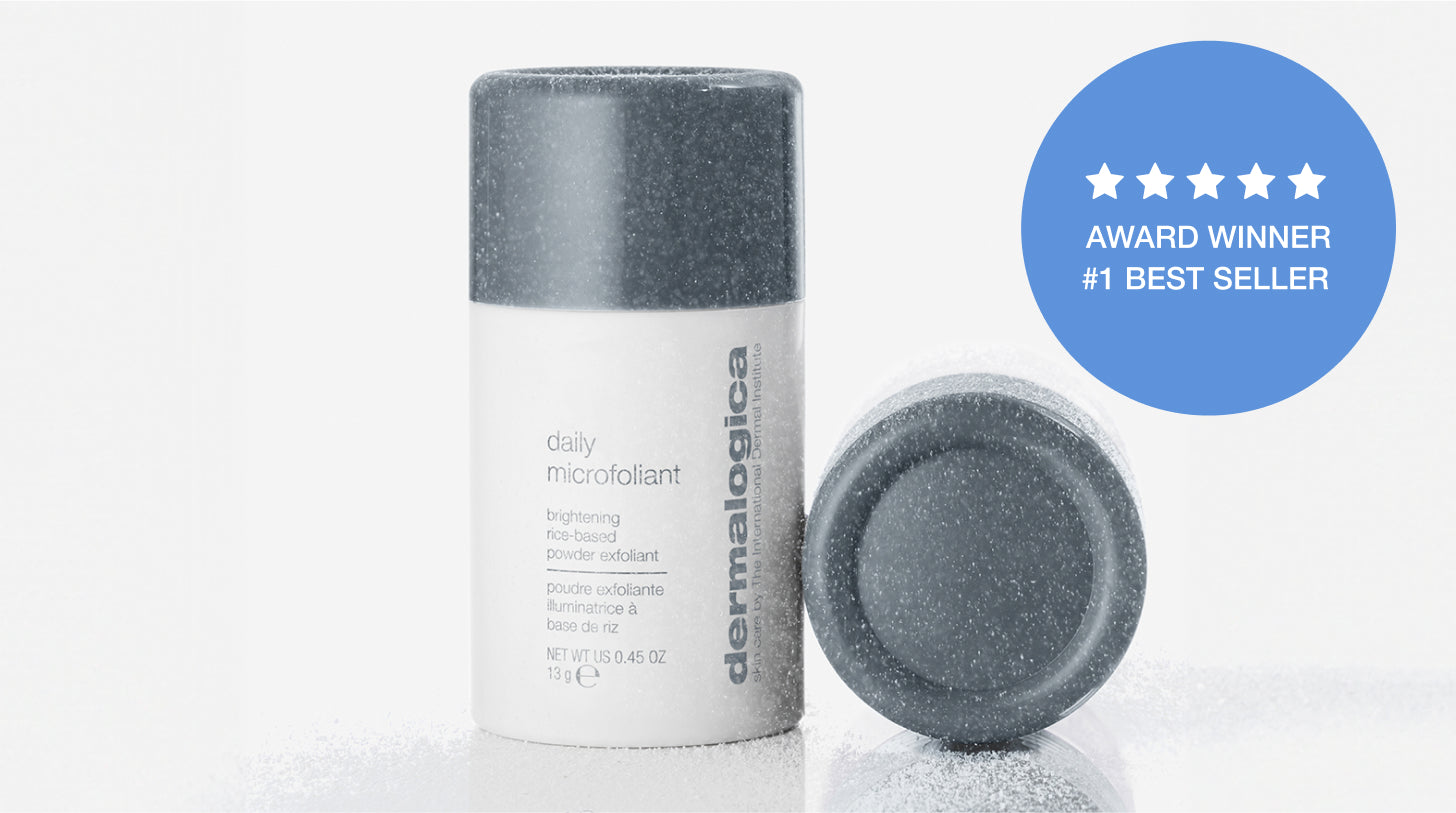 A bottle of Dermalogica Daily Microfoliant stands upright with its cap next to it. A blue badge on the right reads ★ ★ ★ ★ ★ AWARD WINNER #1 BEST SELLER. White powder is scattered around the products.