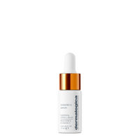 A white bottle of Dermalogica biolumin-c serum with a gold dropper cap is displayed against a plain white background, showcasing its sleek, minimalist look and Dermalogica’s brightening and anti-aging formula.
