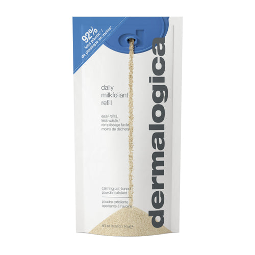 A refill pouch of Dermalogica daily milkfoliant, a gentle exfoliating powder, is pictured with the spout open as beige powder pours onto a white surface. The eco-friendly packaging emphasizes its refillable design.