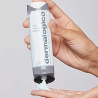 A tube of Dermalogica hydro masque exfoliant features blue gel with exfoliating bamboo beads, a gray and white cap, vertical Dermalogica branding, and hydrating benefits from snow mushroom extract.