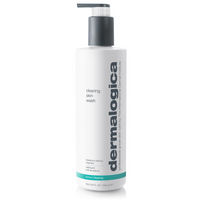 A white Dermalogica clearing skin wash bottle with a gray cap and teal accent band displays the brand name in large gray letters. This foaming cleanser contains salicylic acid to help clear and prevent breakouts.
