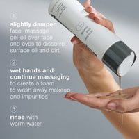 A white Dermalogica oil to foam total cleanser bottle with a gray flip-top lid and bold gray text effectively removes make-up and cleanses skin, transforming from oil to foam.