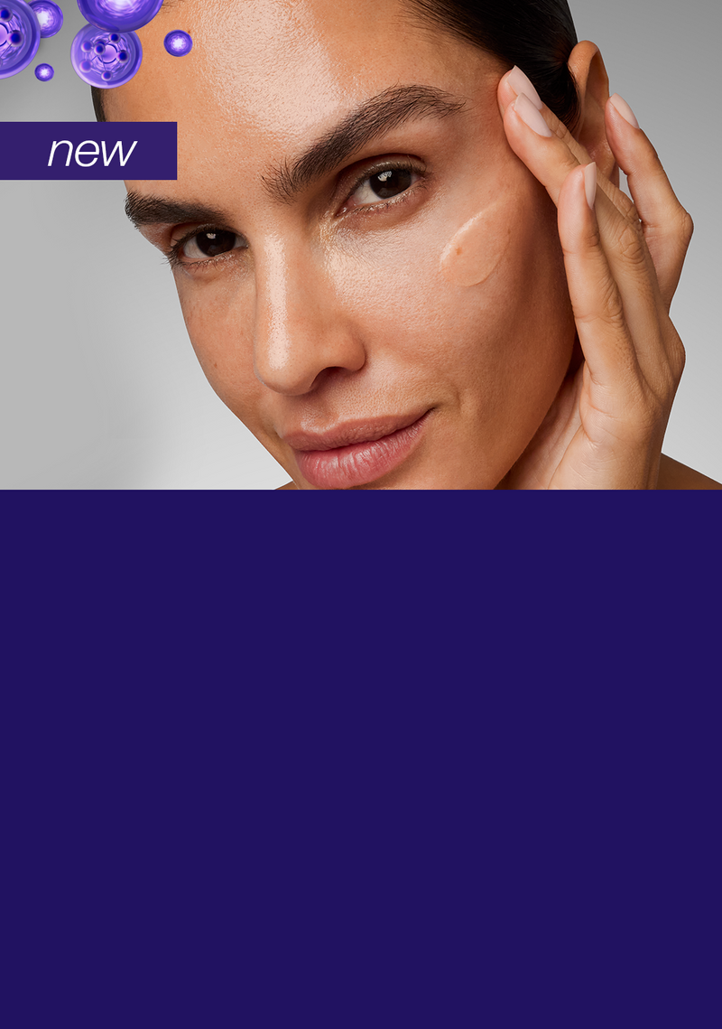 A person with clear skin touches their cheek while smiling slightly. The word “new” appears on a purple banner in the top left, with purple spheres nearby. The lower half of the image is filled with a solid purple color.