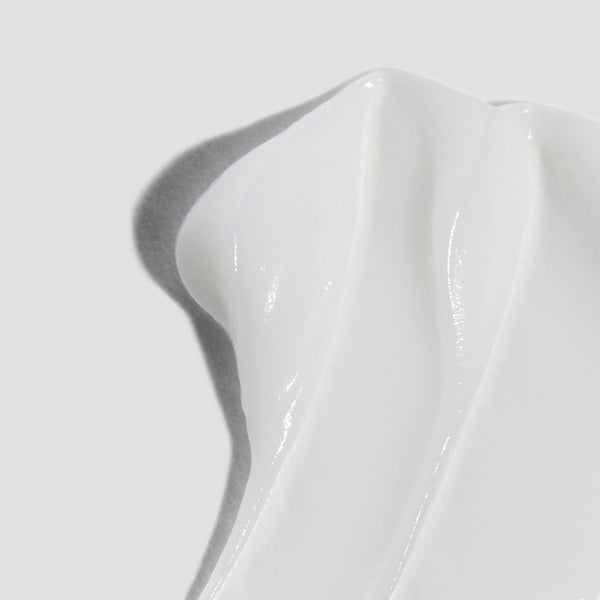 Close-up of Dermalogica's calm water gel, a smooth, creamy white formula with glossy peaks on a light gray background—this hyaluronic acid moisturiser hydrates and soothes dry skin for lasting moisture.