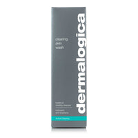 A white Dermalogica clearing skin wash bottle with a gray cap and teal accent band displays the brand name in large gray letters. This foaming cleanser contains salicylic acid to help clear and prevent breakouts.