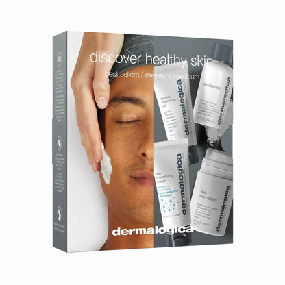 A Dermalogica discover healthy skin kit box featuring a person applying cleanser to their face, displayed alongside a tube of cleanser, pre-cleanse oil, face cream, and exfoliating powder for a complete skin care regimen.