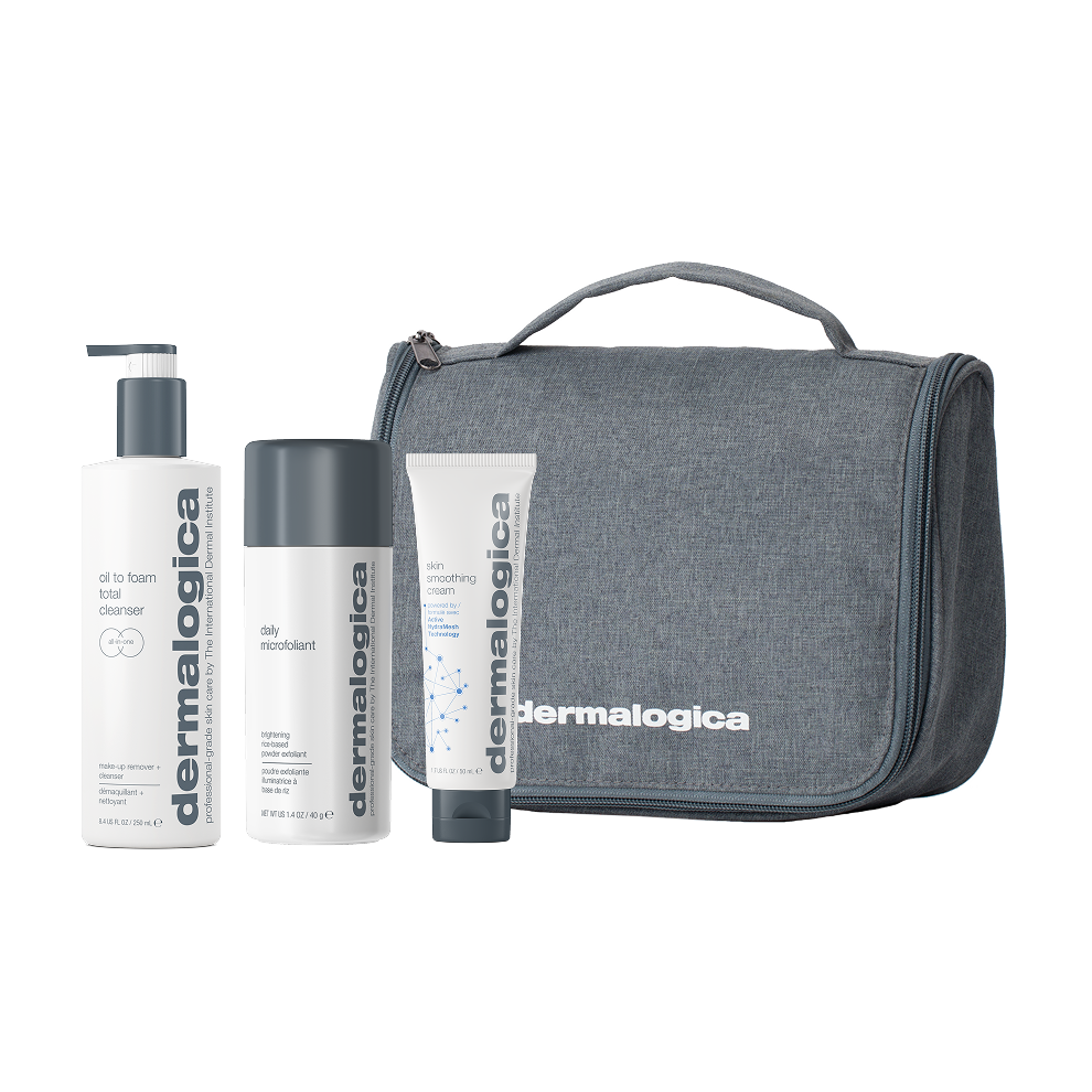 Three Fast Bundle skincare products—including a Skin Smoothing Cream and a Daily Exfoliant—are featured alongside a gray fabric travel bag with a zipper and handle, all labeled with the Fast Bundle brand name. This men's daily face + body skin care bundle is presented against a white background.